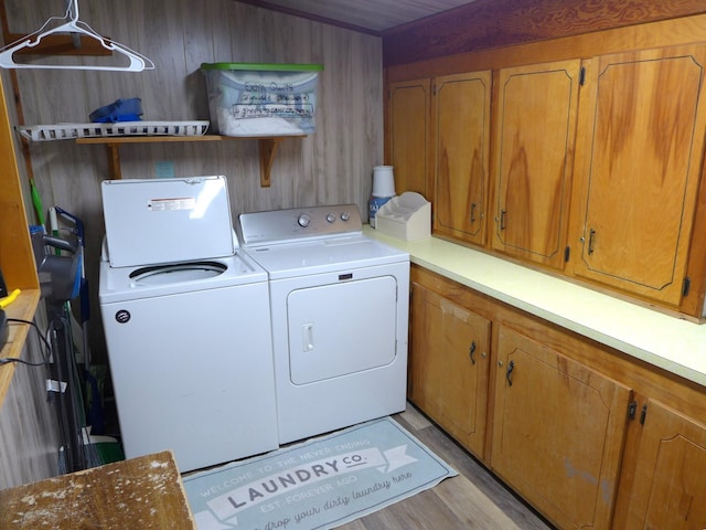 1001 Palmetto Blvd, Edisto Island, SC 29438 - washroom featuring cabinet space, washer and dryer, and light wood-style floors