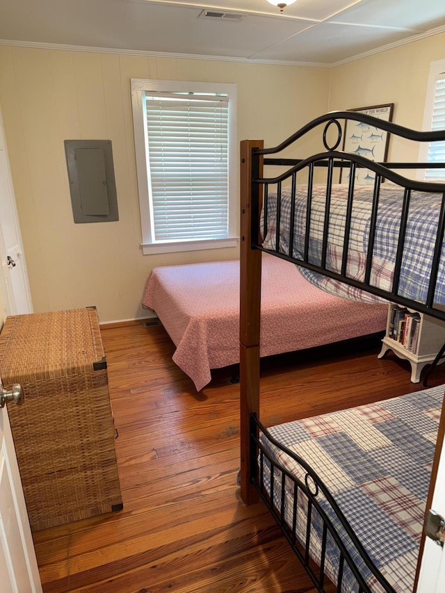 1001 Palmetto Blvd, Edisto Island, SC 29438 - bedroom with electric panel, wood-type flooring, and ornamental molding