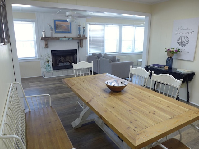1001 Palmetto Blvd, Edisto Island, SC 29438 - dining area with dark wood-style floors, ceiling fan, plenty of natural light, and a fireplace