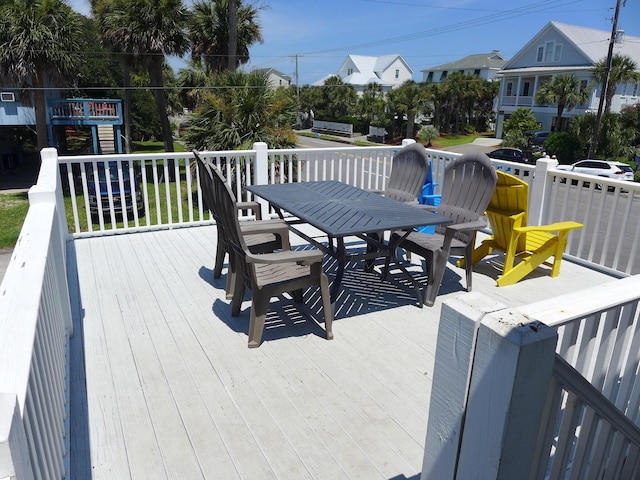 1001 Palmetto Blvd, Edisto Island, SC 29438 - wooden deck with outdoor dining space and a residential view