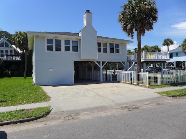 1001 Palmetto Blvd, Edisto Island, SC 29438 - beach home featuring a carport, stairway, concrete driveway, and a chimney