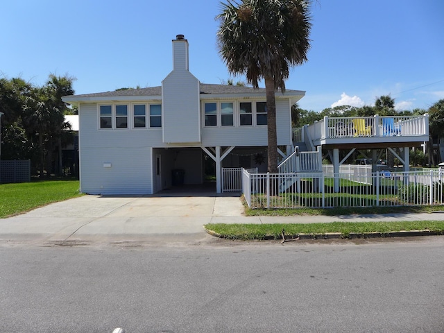 1001 Palmetto Blvd, Edisto Island, SC 29438 - view of front of home with a carport, concrete driveway, stairway, and a chimney