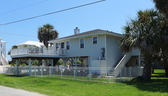 1001 Palmetto Blvd, Edisto Island, SC 29438 - rear view of house with a chimney and a deck