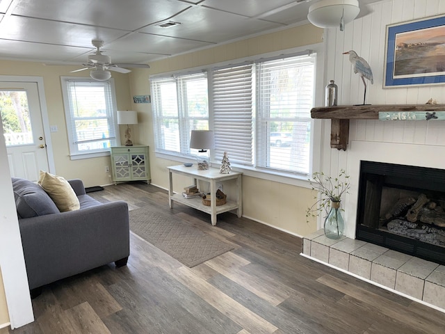 1001 Palmetto Blvd, Edisto Island, SC 29438 - living room featuring a ceiling fan, a fireplace with raised hearth, and healthy amount of natural light