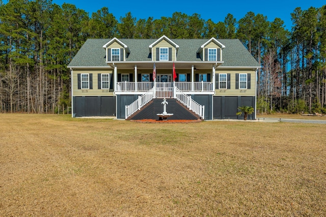 view of front of home featuring stairway, a porch, a shingled roof, and a front lawn