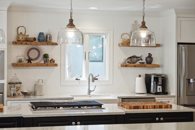 kitchen with white cabinetry, sink, stainless steel appliances, and decorative light fixtures