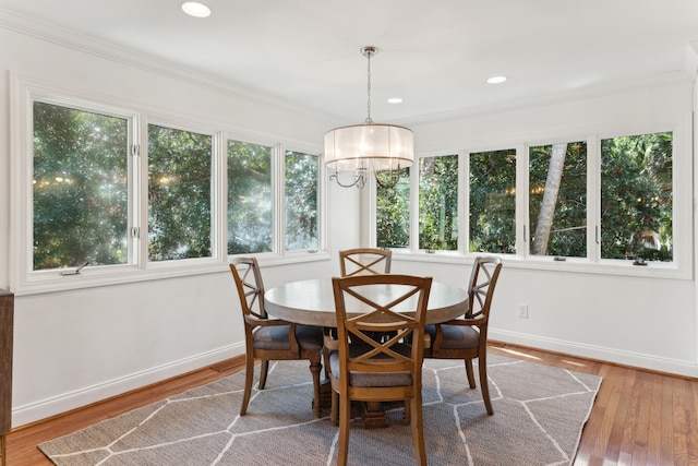 sunroom / solarium featuring a wealth of natural light and a chandelier