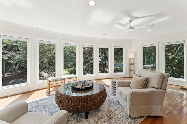 sunroom / solarium featuring ceiling fan