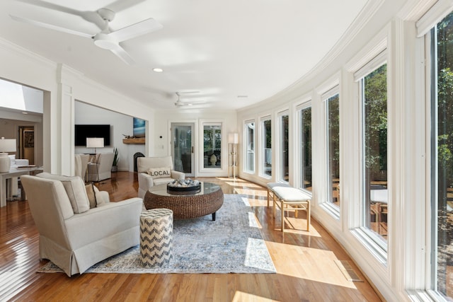 sunroom / solarium featuring ceiling fan