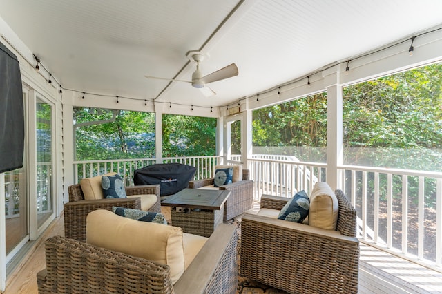 sunroom / solarium featuring ceiling fan and plenty of natural light