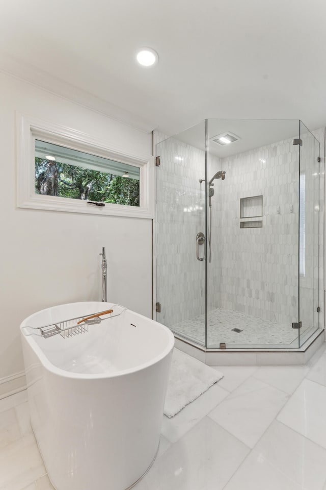 bathroom with shower with separate bathtub