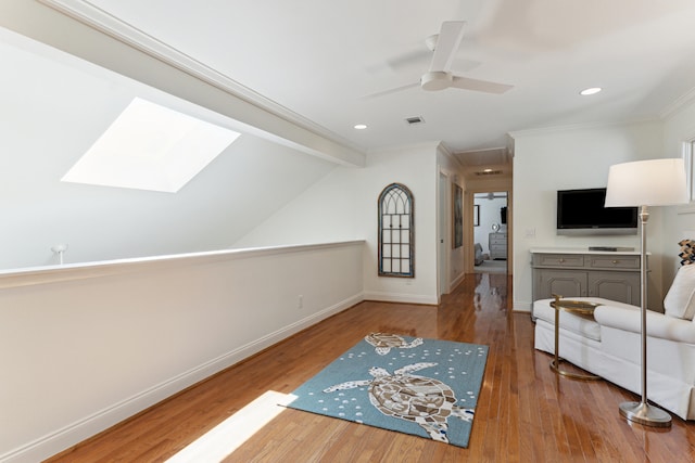 interior space featuring vaulted ceiling with beams, ceiling fan, hardwood / wood-style floors, and crown molding