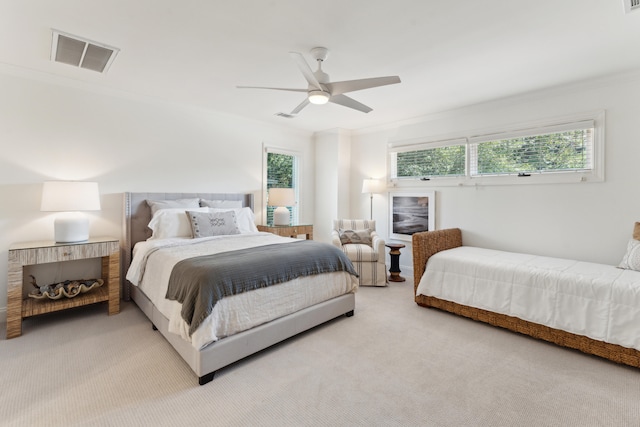 carpeted bedroom featuring multiple windows, ceiling fan, and ornamental molding