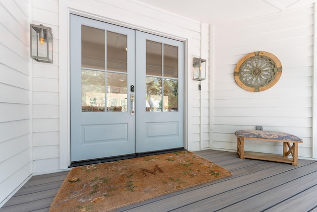 property entrance featuring french doors and covered porch