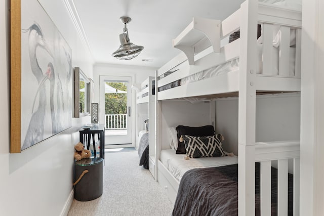 bedroom with carpet, access to exterior, and crown molding