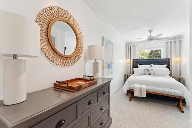 carpeted bedroom featuring ceiling fan and crown molding