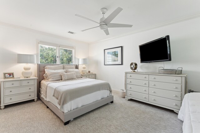 bedroom with light colored carpet, ceiling fan, and ornamental molding