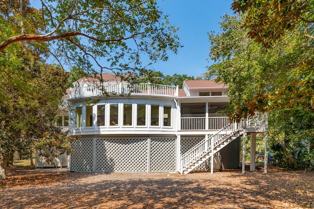 rear view of property with a sunroom