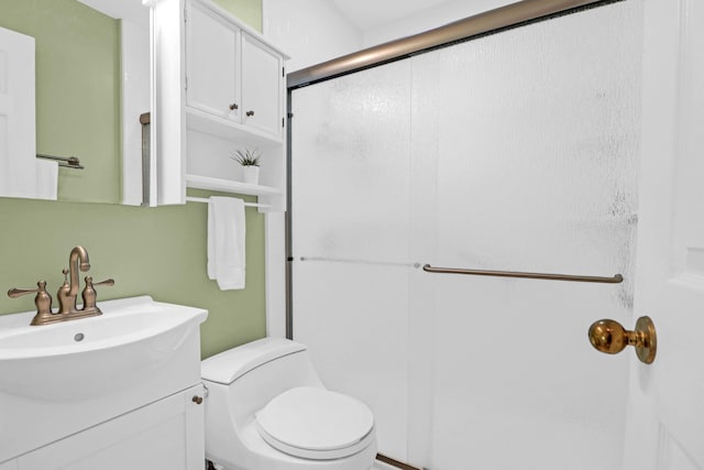 bathroom featuring an enclosed shower, toilet, and vanity