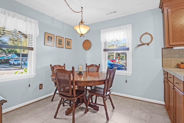 dining space with plenty of natural light, baseboards, and visible vents