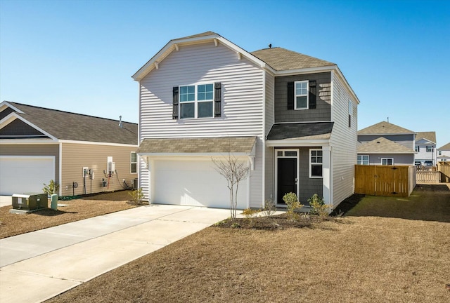 view of front property with a garage and cooling unit