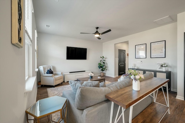 living room with dark wood-type flooring and ceiling fan