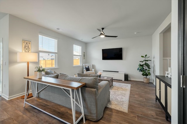 living room with ceiling fan and dark hardwood / wood-style floors