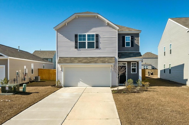 view of property featuring central AC unit and a garage