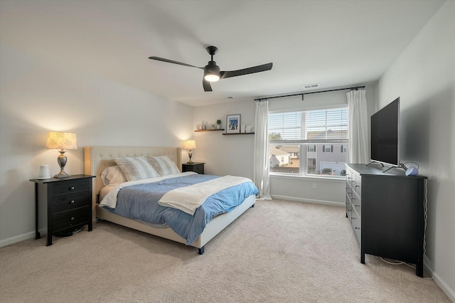 bedroom with ceiling fan and light carpet