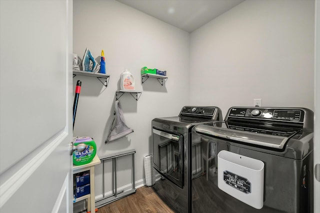 washroom with dark wood-type flooring and separate washer and dryer