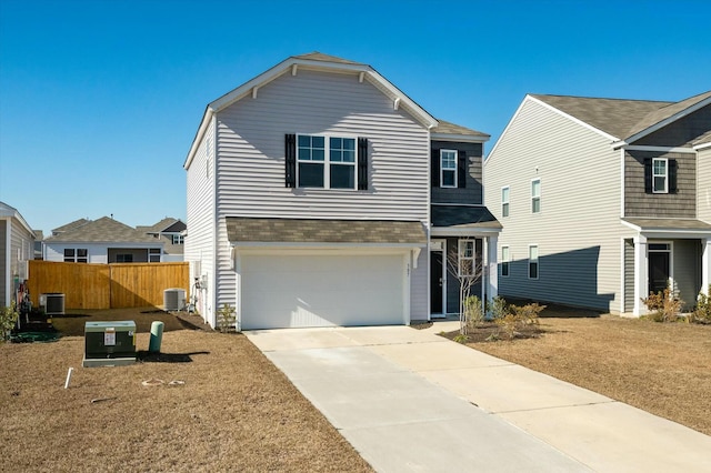 front of property with a front lawn, cooling unit, and a garage