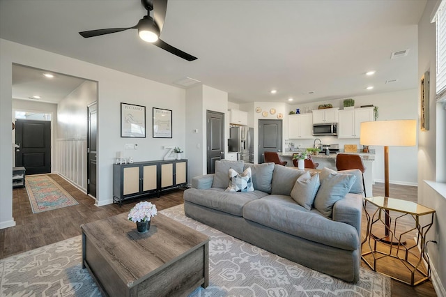 living room with ceiling fan and hardwood / wood-style floors