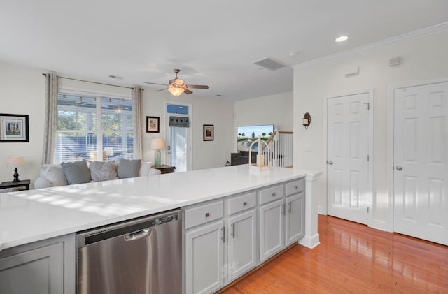 kitchen featuring stainless steel dishwasher, ceiling fan, and light hardwood / wood-style floors