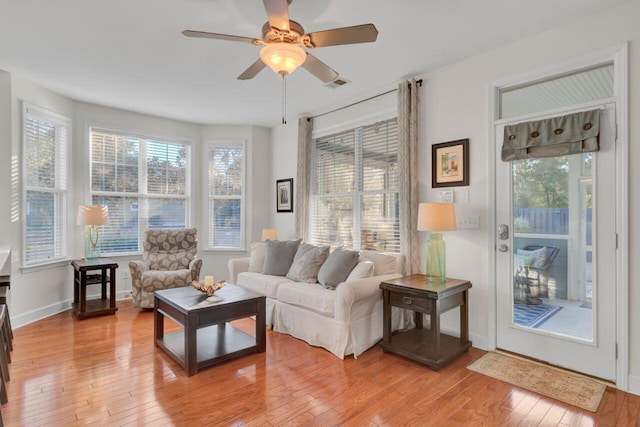 living room with light wood-type flooring and ceiling fan