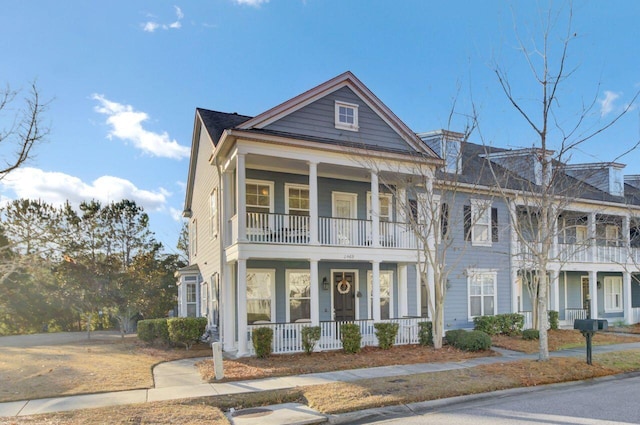 view of front of property featuring a porch and a balcony