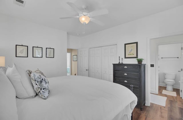 bedroom with dark hardwood / wood-style flooring, a closet, ensuite bath, and ceiling fan