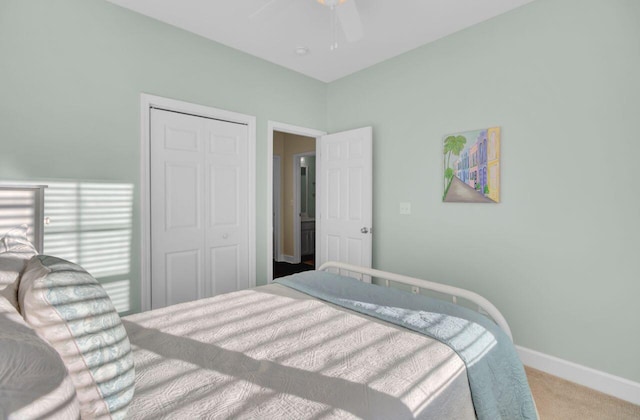 carpeted bedroom with ceiling fan and a closet