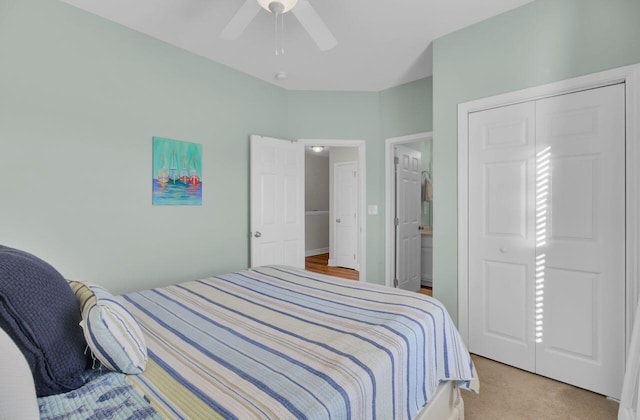 bedroom featuring ensuite bath, ceiling fan, and light carpet