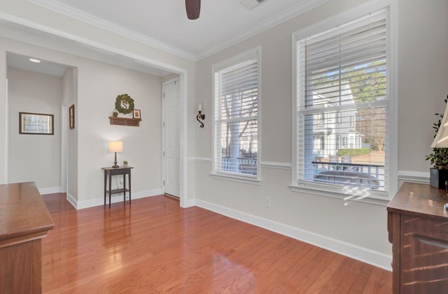 interior space with crown molding, ceiling fan, and hardwood / wood-style flooring