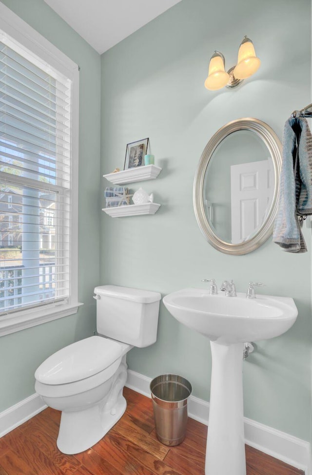 bathroom featuring hardwood / wood-style floors and toilet