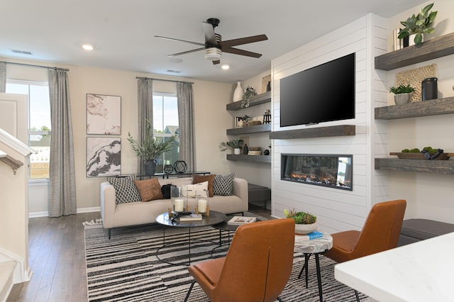 living room with a fireplace, ceiling fan, and hardwood / wood-style floors