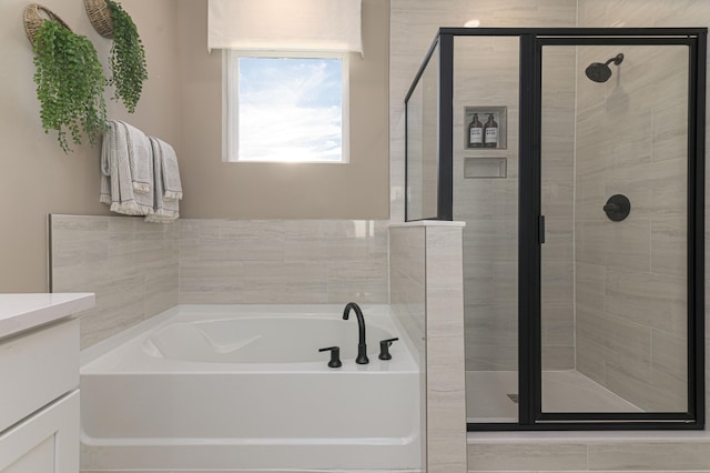 bathroom with shower with separate bathtub and vanity