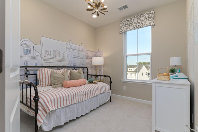 carpeted bedroom with a notable chandelier