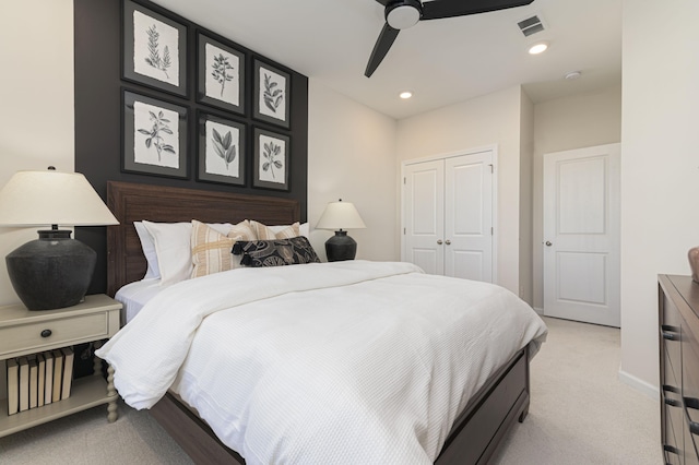 bedroom featuring a closet, ceiling fan, and light colored carpet