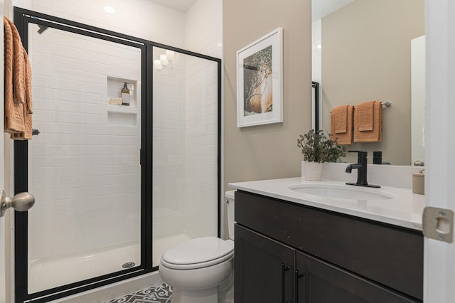 bathroom with vanity, toilet, and walk in shower