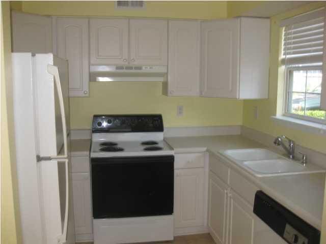 kitchen with range with electric stovetop, dishwasher, sink, white cabinets, and white refrigerator