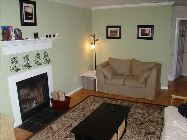 living room with hardwood / wood-style flooring and crown molding