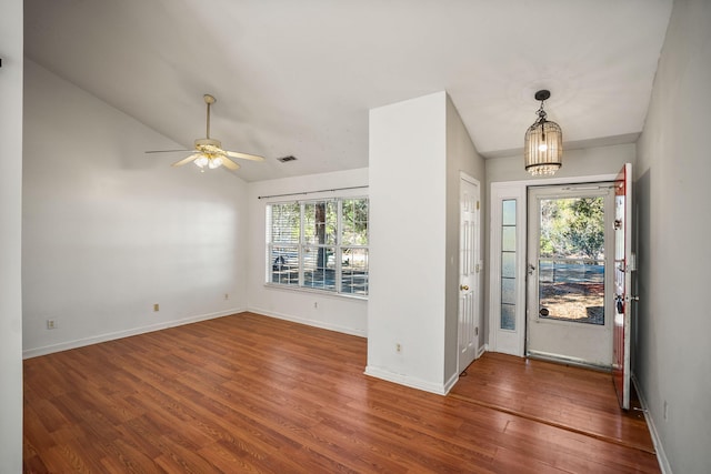 entryway featuring vaulted ceiling, ceiling fan with notable chandelier, and hardwood / wood-style floors