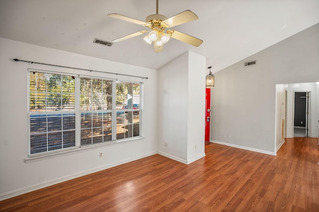 spare room with lofted ceiling, ceiling fan, and hardwood / wood-style floors