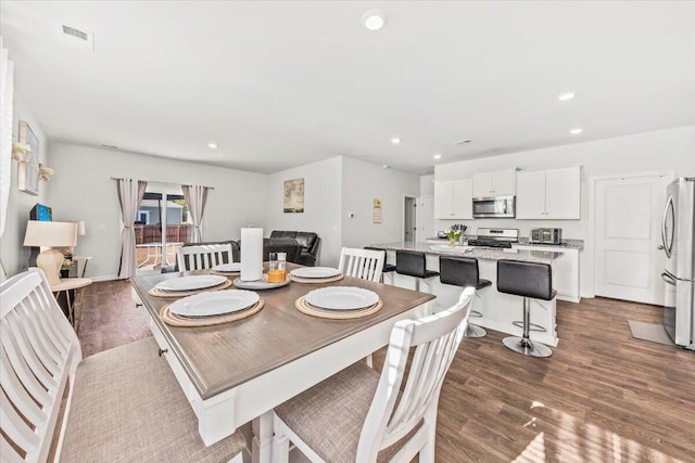 dining space with hardwood / wood-style floors